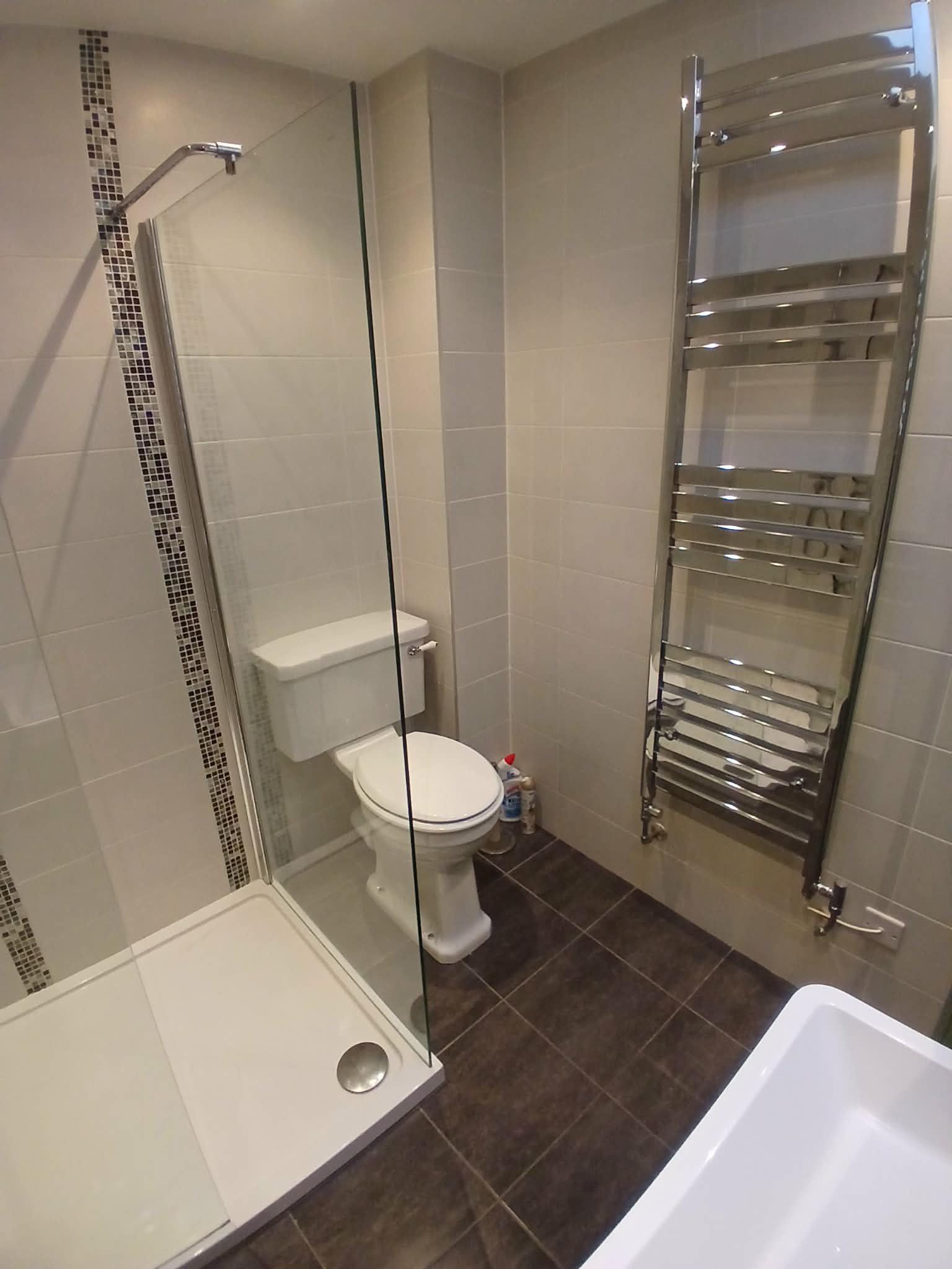 Shower enclosure with heated towel rail