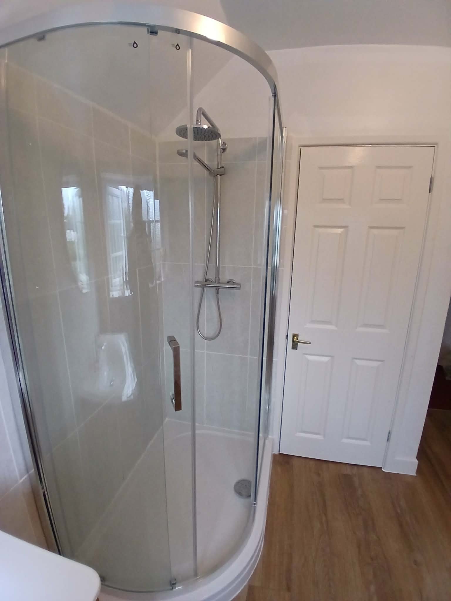 Curved shower enclosure